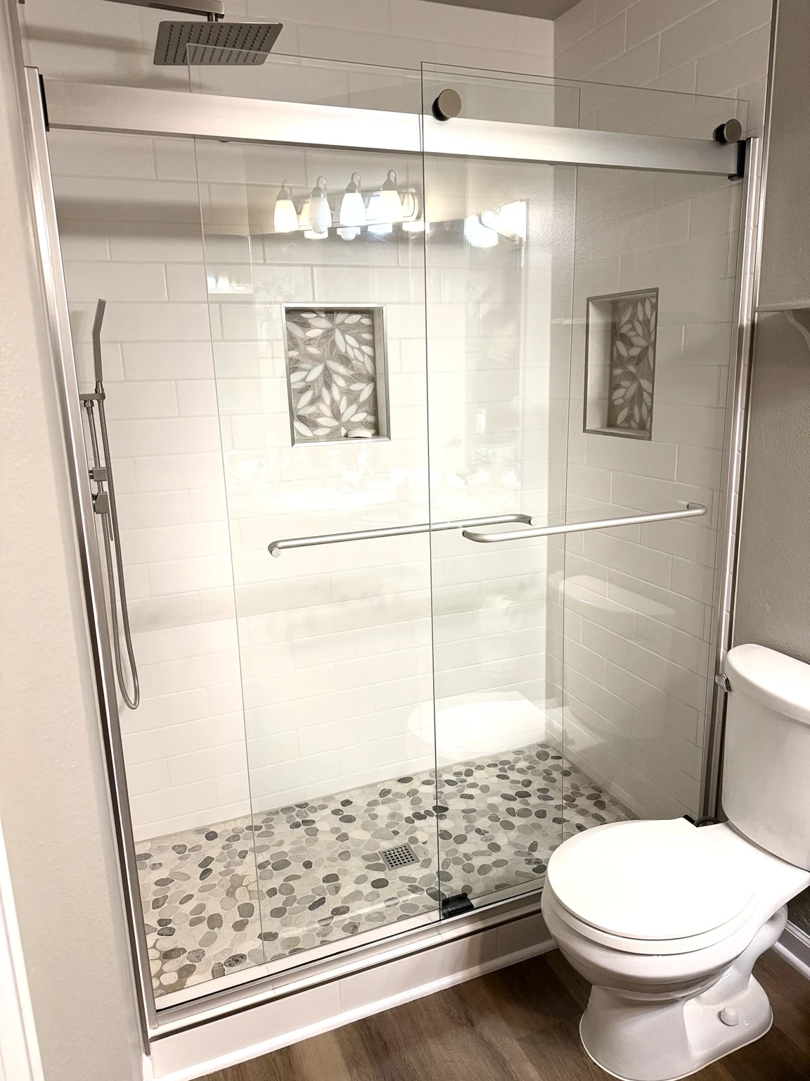 Subway tile shower with pebble floor